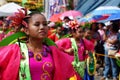 Girl carnival dancers in various costumes dance along the road