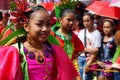 Girl carnival dancers in various costumes dance along the road