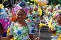 Girl carnival dancers in various costumes dance along the road