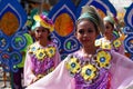 Girl carnival dancers in various costumes dance along the road