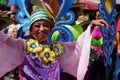 Girl carnival dancers in various costumes dance along the road