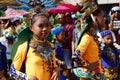 Girl carnival dancers in various costumes dance along the road