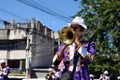 Male band member play trumpet during town festivity procession
