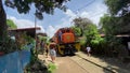 Curious slum-dwellers gather around the locomotive train that unexpectedly stopped along their area