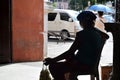 Mendicant woman selling sampaguita flowers at church portal. silhouettes Royalty Free Stock Photo