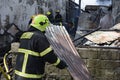 Local fireman help extinguish fire during house fire that gutted interior shanty houses Royalty Free Stock Photo