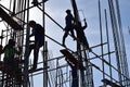 A group of Filipino Construction steel workers assembling steel bars on high-rise building with no proper protective suits and saf