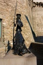 San Panza statue and Don Quixote built in black steel by an unknown author against a medieval brick wall