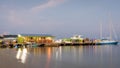 Passengers getting off water taxi boat after arriving to San Pedro, Ambergris Caye from Belize City at dusk Royalty Free Stock Photo