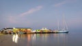 Passengers getting off water taxi boat after arriving to San Pedro, Ambergris Caye from Belize City at dusk Royalty Free Stock Photo