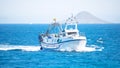 San Pedro del Pinatar, Murcia, Spain, June 17, 2020: Fishing boat returns to port. Fisher men working at a boat sailing through