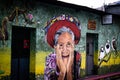 San Pedro La Laguna, Guatemala- May 21, 2023: Mural on a building wall illustrating face of a happy older Mayan woman with