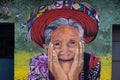 San Pedro La Laguna, Guatemala- May 21, 2023: Mural on a building wall illustrating face of a happy older Mayan woman with Royalty Free Stock Photo