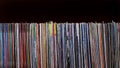 Many 33 rpm album vinyl records on a black background