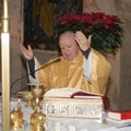 Senior priest preparing celebration of the sacrament of the Eucharist Royalty Free Stock Photo