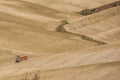 SAN QUIRICO D`ORCIA, TUSCANY / ITALY - OCTOBER 31, 2016: Undefined man on a tractor in the beautiful tuscan landscape Royalty Free Stock Photo