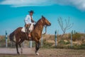 San Rafael, Argentina, October 10th, 2021; Argentine cowboy gaucho walks his horse past camera, in Patagonia