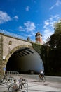 San Sebastian Donostia, Basque country, Spain: A young woman on a bicycle rides under an stone bridge Royalty Free Stock Photo