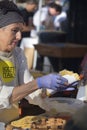 San Sebastian, Spain - Dec 21, 2022: Basque farmers roasting Txistorra (fresh chorizo), typical street food on Saint