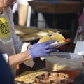 San Sebastian, Spain - Dec 21, 2022: Basque farmers roasting Txistorra (fresh chorizo), typical street food on Saint Royalty Free Stock Photo