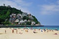 SAN SEBASTIAN, SPAIN - JULY 24, 2018: Ondarreta beach in a sunny day. Igeldo hill in background.