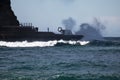 San Sebastian, Spain - March 16, 2018: people watching huge scenic splashing waves by scenic The comb of the wind / Peine del vien