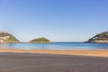 Unknown people walking on the beach called La Concha. Bay of Biscay in San Sebastian in autumn. Wide aerial beach in morning. Royalty Free Stock Photo