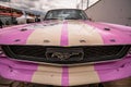 Front of a pink and cream Ford Mustang race car