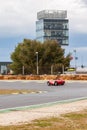 Jarama circuit control tower and vehicle passing through the circuit curve