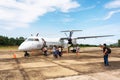 Travellers leave Bombardier Q400 airplane Philippine Airlines