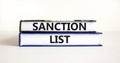 Sanction list symbol. Books with concept words Sanction list on beautiful white background. Business political sanction list