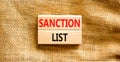 Sanction list symbol. Wooden blocks with concept words Sanction list on beautiful canvas background. Business political sanction