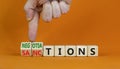 Sanctions or limitations symbol. Businessman turns cubes, changes the word sanctions to limitations. Beautiful orange table,