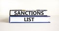 Sanctions list symbol. Books with concept words Sanctions list on beautiful white background. Business political sanctions list