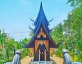 The Sanctuary with gable roof and chofa decors, Baan Dam Black House, on May 11 in Chiang Rai, Thailand