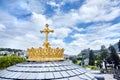 Sanctuary of Lourdes. Dome of The Basilica of Our Lady of the Rosary. The Golden Crown and the Cross. Blue sky with clouds Royalty Free Stock Photo
