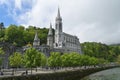 The Sanctuary of Our Lady of Lourdes, a Catholic Marian shrine & pilgrimage site in Lourdes, France, from across the Gave of Pau