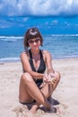 Sand as the time slips through your fingers. Girl holding a sand sea background. Concept of vacation in warmer climes Royalty Free Stock Photo