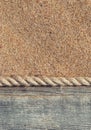 Sand background with old wood and rope Royalty Free Stock Photo