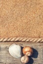 Sand background with old wood, seashells and rope Royalty Free Stock Photo