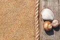 Sand background with old wood, seashells and rope Royalty Free Stock Photo