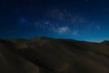 Sand mountain with night sky background. Royalty Free Stock Photo