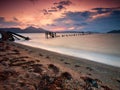 Sand beach and ruined pier into the sea Royalty Free Stock Photo