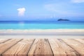 Wood table with blue sea and sand beach background Royalty Free Stock Photo