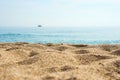 Sand on the beach close up with blurred sea, ship and waves on a background. Royalty Free Stock Photo