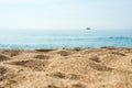 Sand on the beach close up with blurred sea, ship and waves on a background. Royalty Free Stock Photo