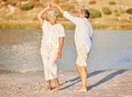 Sand, beach and dancing happy senior couple on summer retirement holiday travel or spring vacation by water. Love fun Royalty Free Stock Photo