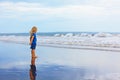 On sand beach dreaming child look at sea surf landscape