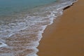 Sand on the beach and foamy water Royalty Free Stock Photo