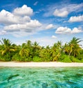 Sand beach with palm trees and cloudy blue sky. Tropical island Royalty Free Stock Photo